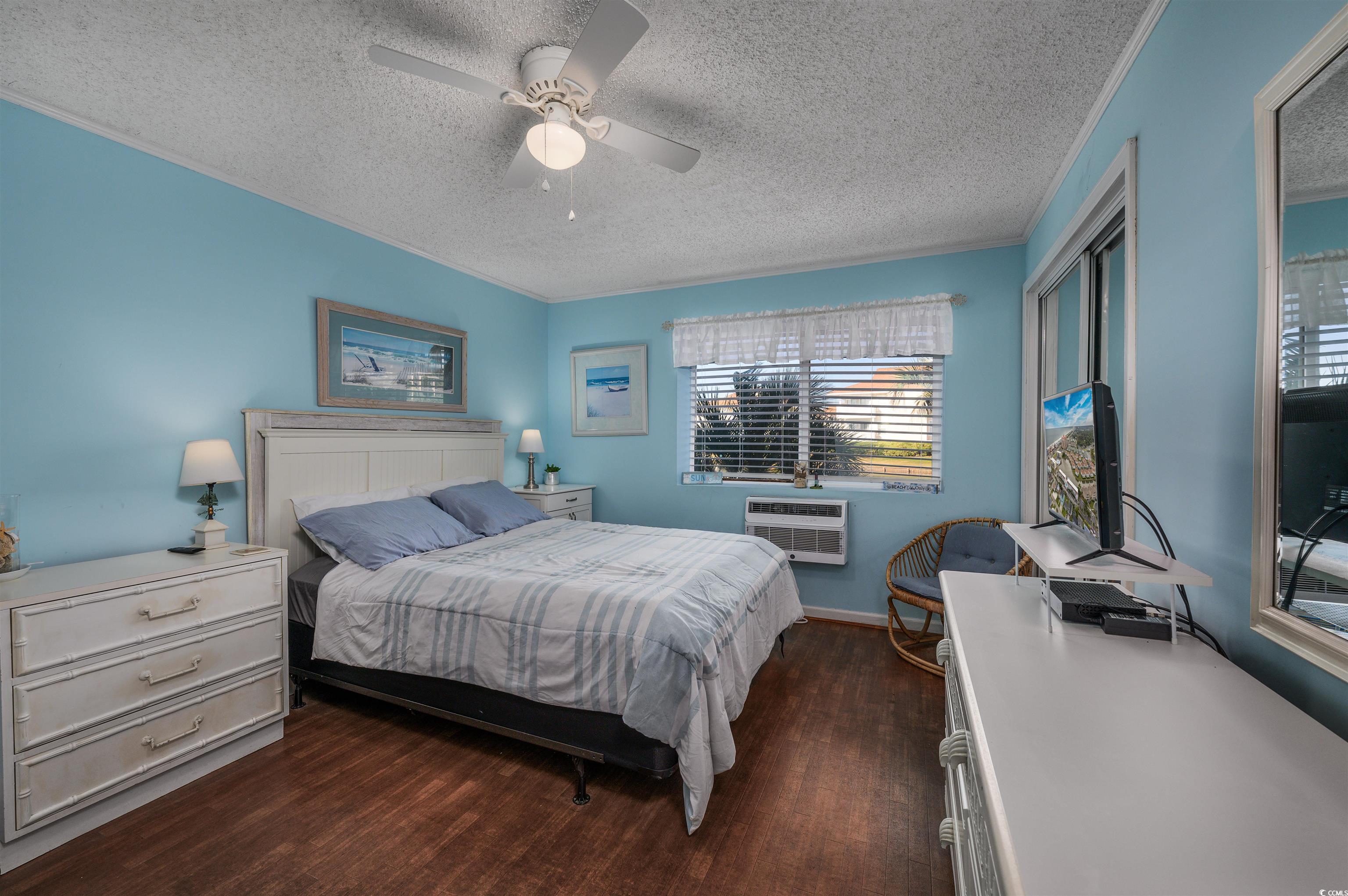 1919 Spring Street, Unit B14 North Myrtle Beach, SC 29582 - Photo 13 of 25 Bedroom featuring a textured ceiling, an AC wall u