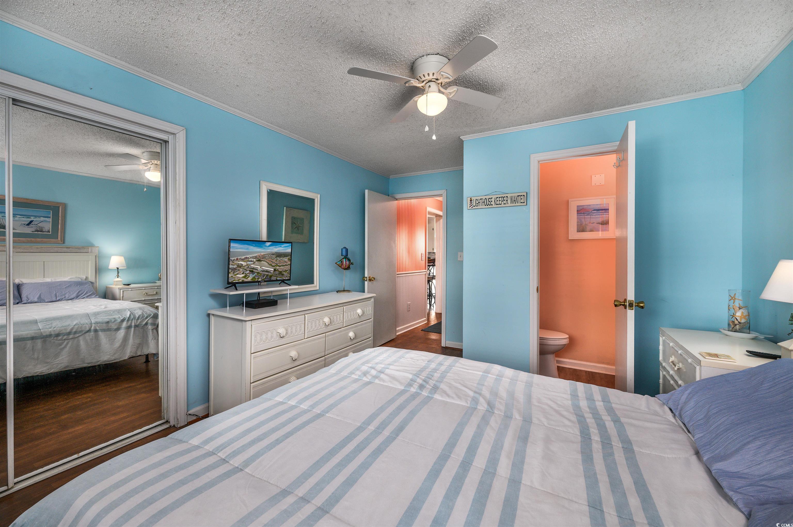1919 Spring Street, Unit B14 North Myrtle Beach, SC 29582 - Photo 14 of 25 Bedroom with ceiling fan, a textured ceiling, a cl