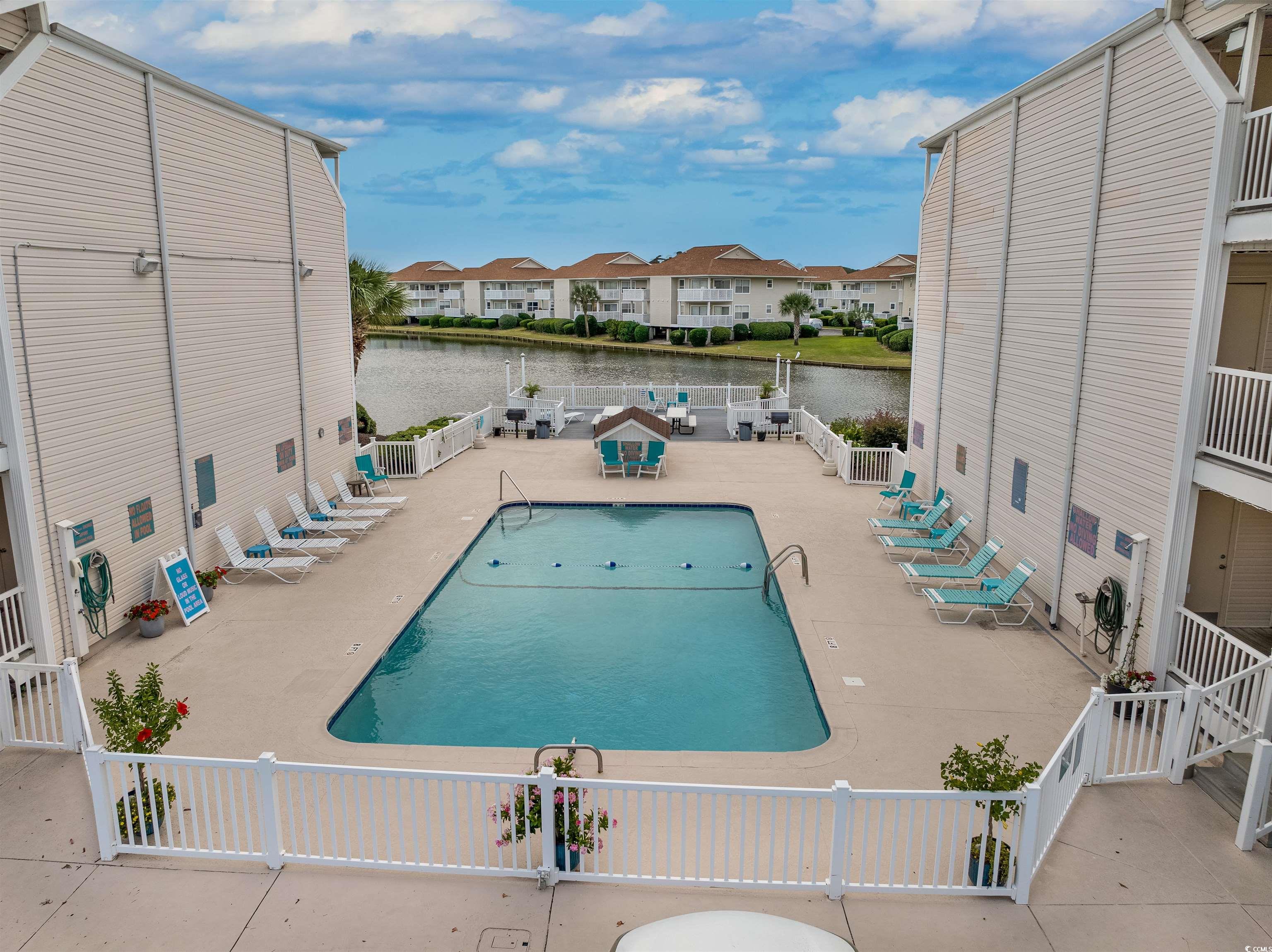1919 Spring Street, Unit B14 North Myrtle Beach, SC 29582 - Photo 20 of 25 View of swimming pool with a patio and a water vie