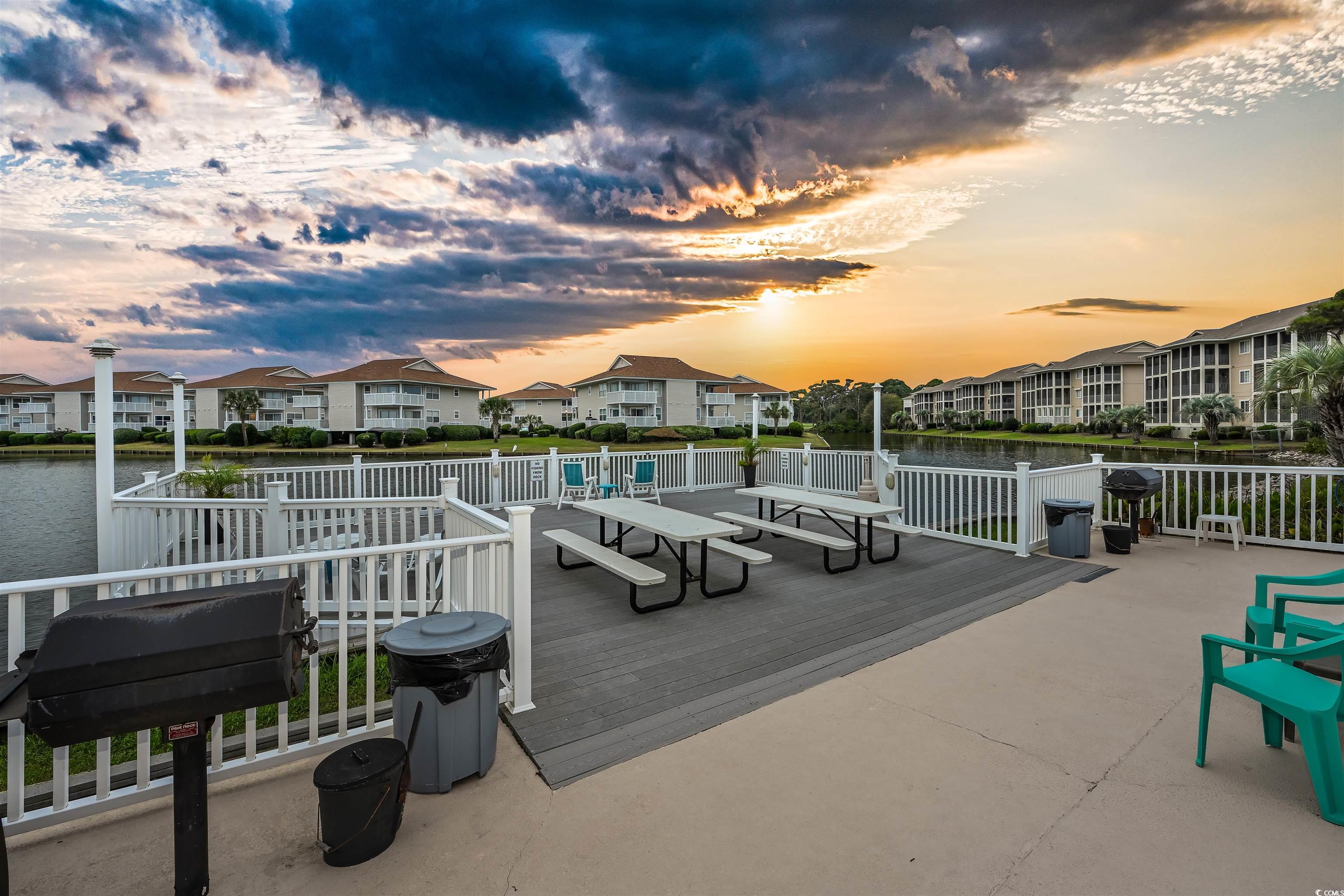 1919 Spring Street, Unit B14 North Myrtle Beach, SC 29582 - Photo 22 of 25 Patio terrace at dusk featuring a water view