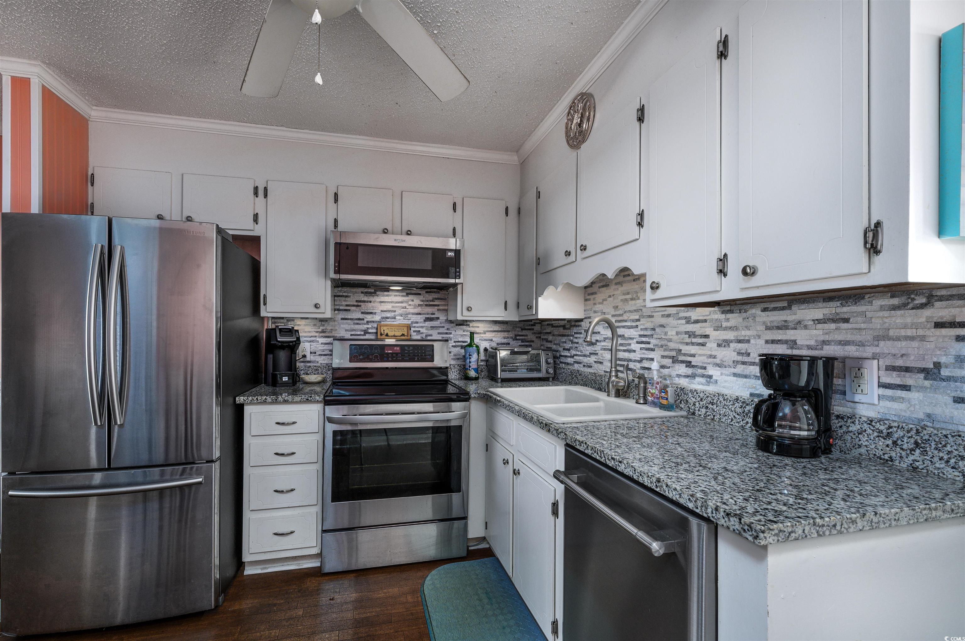1919 Spring Street, Unit B14 North Myrtle Beach, SC 29582 - Photo 4 of 25 Kitchen featuring white cabinetry, ceiling fan, ap