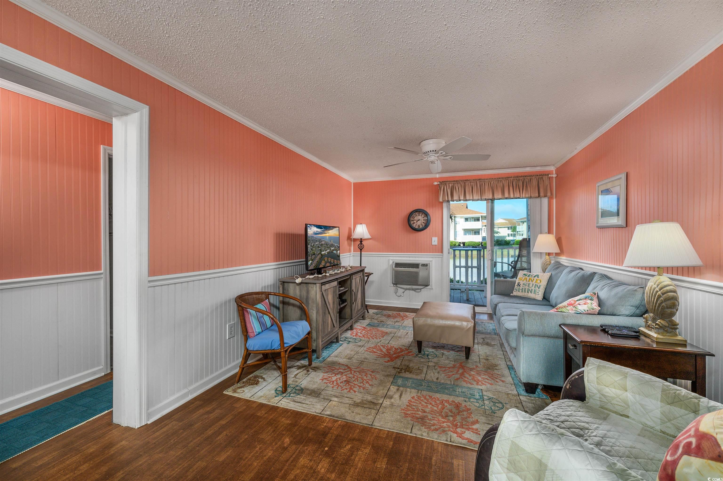 1919 Spring Street, Unit B14 North Myrtle Beach, SC 29582 - Photo 7 of 25 Living room with ornamental molding, ceiling fan,