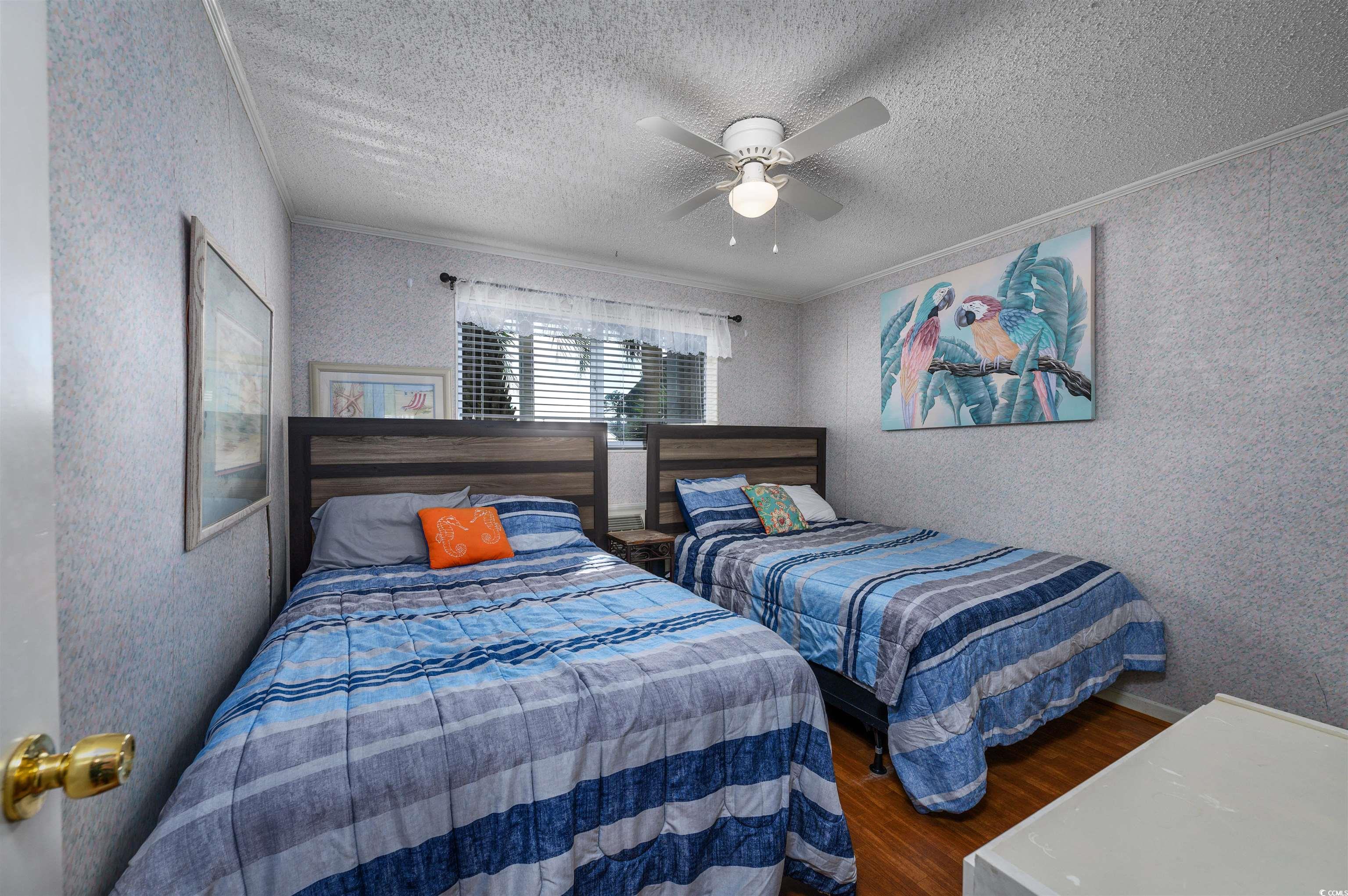 1919 Spring Street, Unit B14 North Myrtle Beach, SC 29582 - Photo 10 of 25 Bedroom featuring a textured ceiling, ceiling fan,