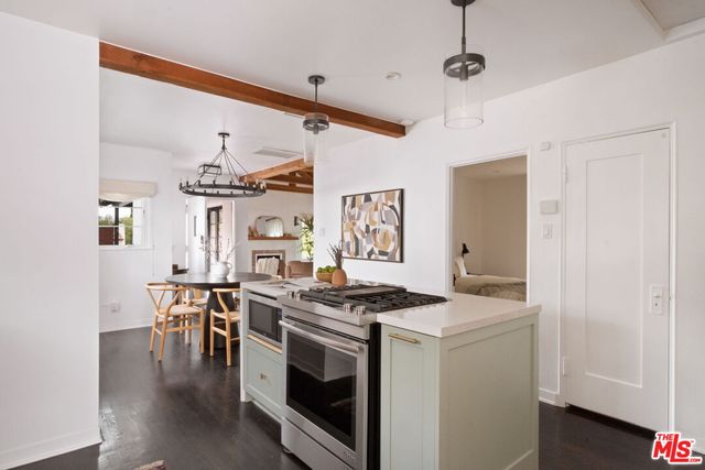 a kitchen that has a stove and a table in it