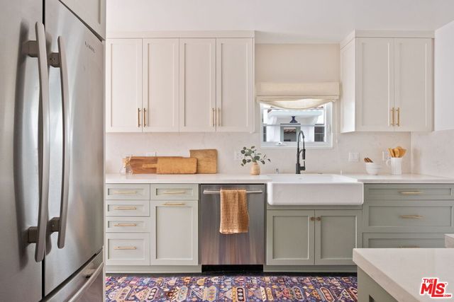 a kitchen with stainless steel appliances a sink stove and refrigerator
