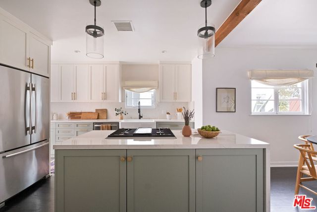 a kitchen with stainless steel appliances a refrigerator sink and cabinets