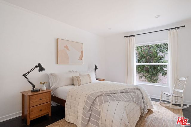 a bedroom with bed and window