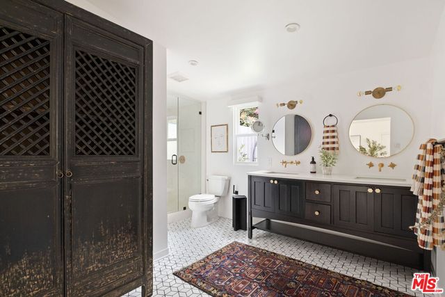 a view of bathroom with shower and mirror