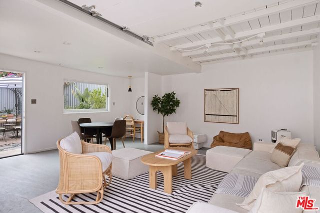 a living room with furniture a window and a table