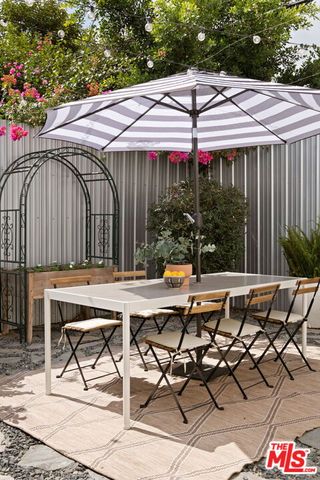 a view of backyard with seating space and wooden deck