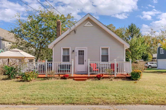 a front view of a house with swimming pool and porch