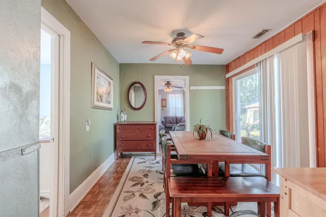 a view of a dining room with furniture and window