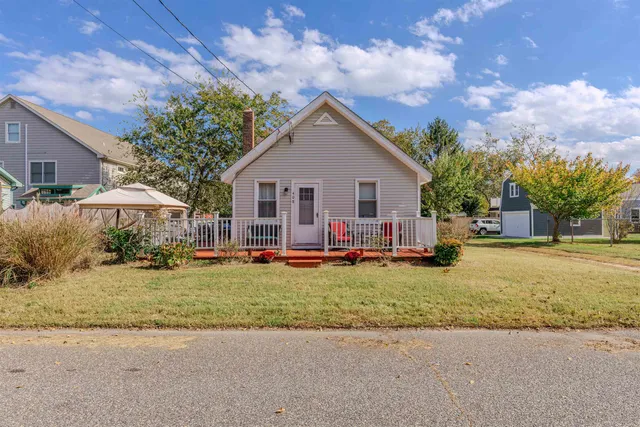 a view of a house with backyard and sitting area