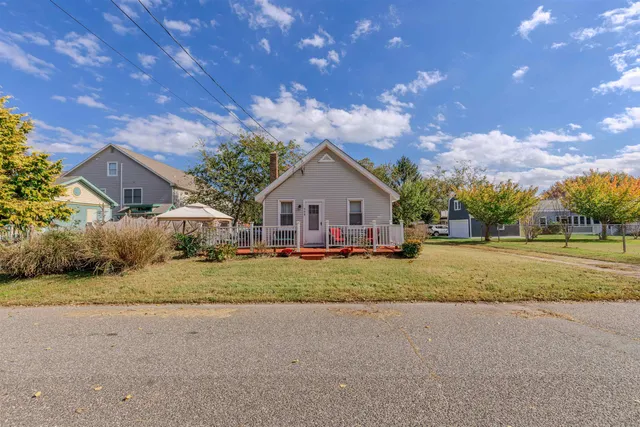 a front view of house with yard and trees