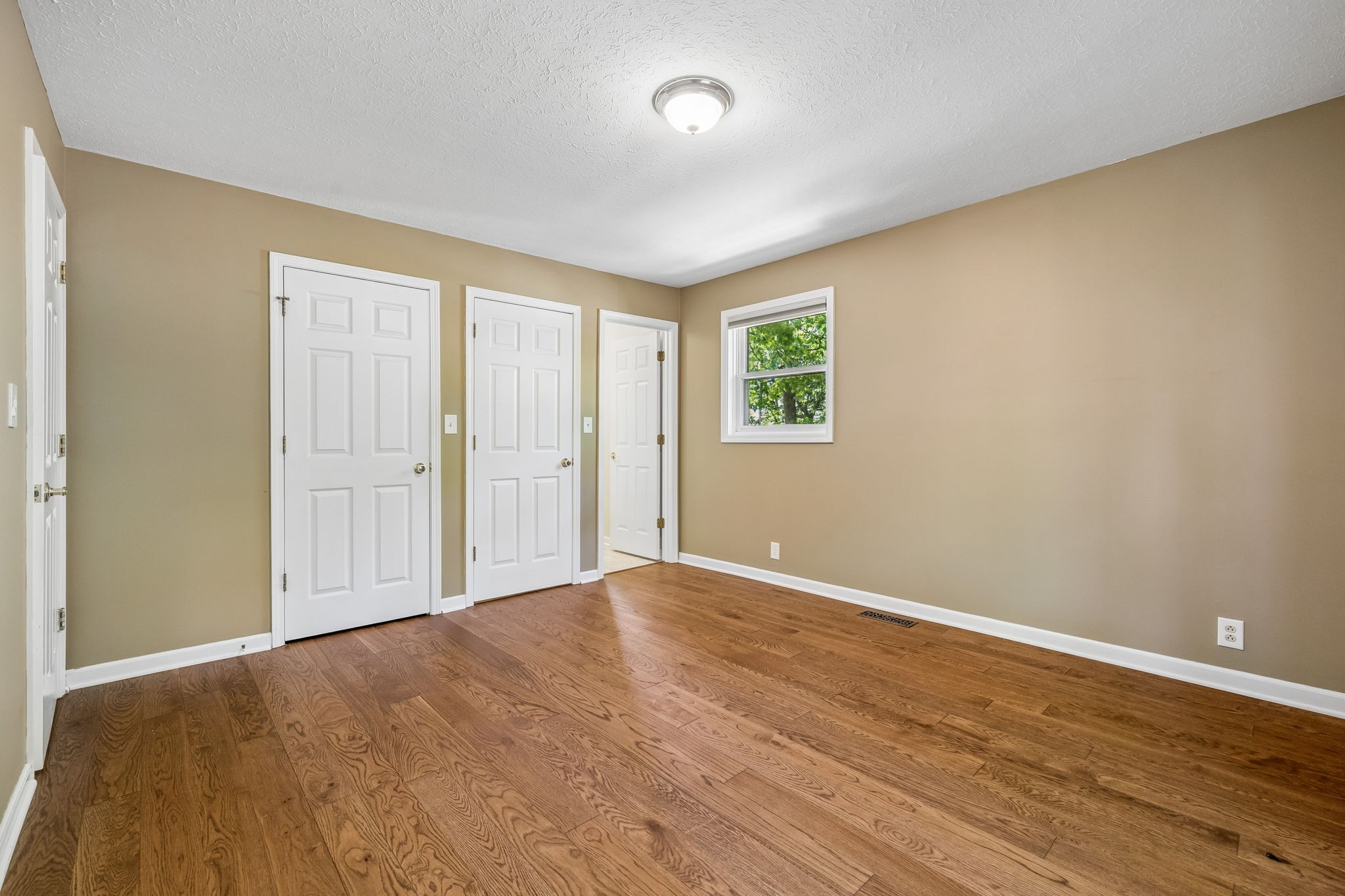 385 Perdue Road Franklin, KY 42134 - Photo 51 of 72 a view of an empty room with wooden floor and a window