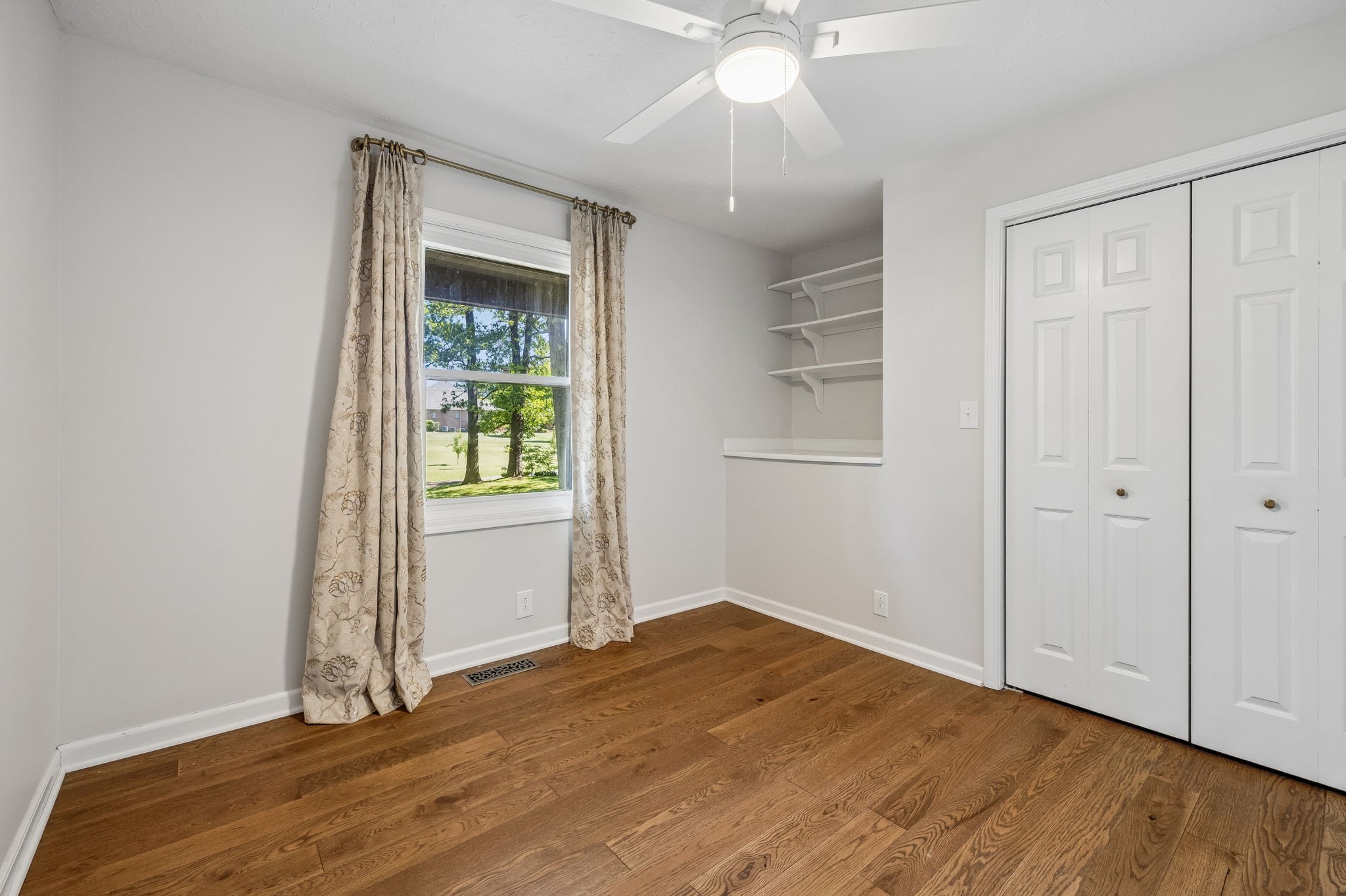 385 Perdue Road Franklin, KY 42134 - Photo 58 of 72 an empty room with wooden floor fan and windows