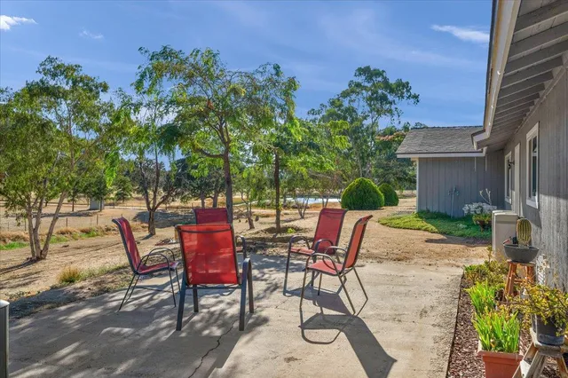 a view of a house with backyard and tree s