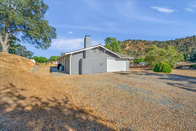 an aerial view of a house with a yard and lake view