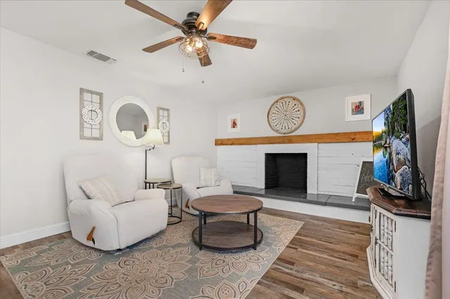 a living room with furniture a clock and a fireplace