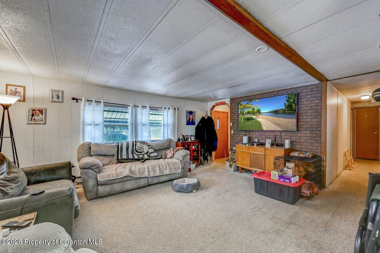 191 Poplar Street Archbald, PA 18403 - Photo 11 of 35 a living room with furniture and a flat screen tv