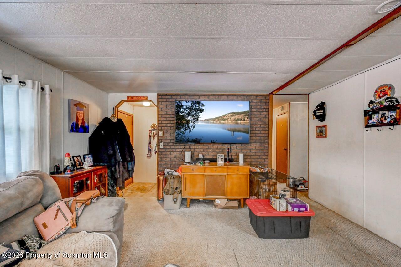 191 Poplar Street Archbald, PA 18403 - Photo 13 of 35 a living room with furniture and a flat screen tv