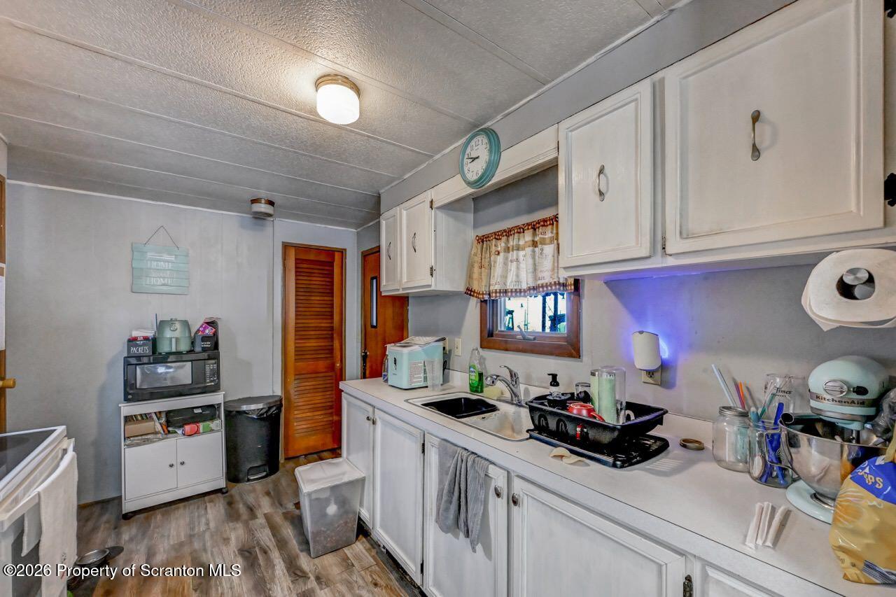 191 Poplar Street Archbald, PA 18403 - Photo 17 of 35 a kitchen that has a lot of cabinets a sink and wooden floor