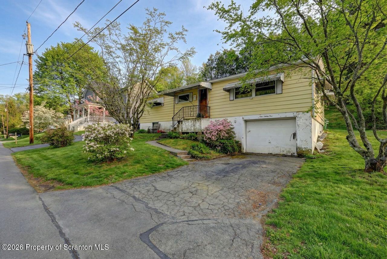 191 Poplar Street Archbald, PA 18403 - Photo 2 of 35 a front view of a house with a yard and a garage