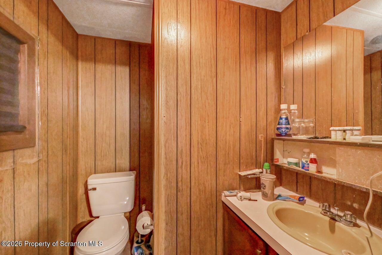 191 Poplar Street Archbald, PA 18403 - Photo 24 of 35 a bathroom with a sink a toilet and shower curtain