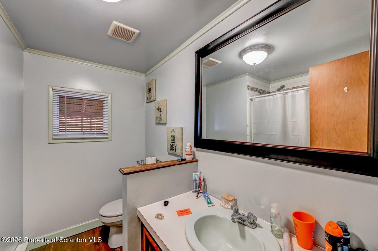 191 Poplar Street Archbald, PA 18403 - Photo 28 of 35 a bathroom with a sink a toilet and mirror