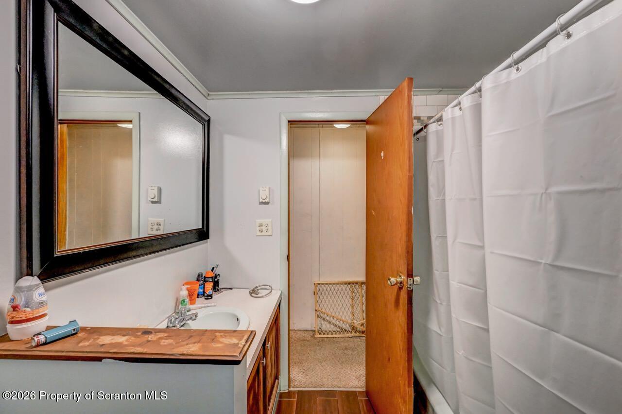 191 Poplar Street Archbald, PA 18403 - Photo 29 of 35 a bathroom with a granite countertop sink and a mirror