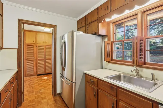a kitchen with stainless steel appliances granite countertop a refrigerator and a sink