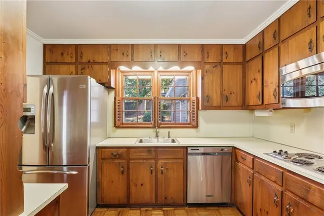 a kitchen with stainless steel appliances granite countertop a refrigerator and a sink