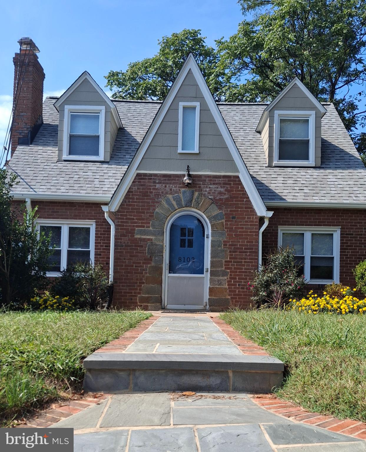 a front view of a house with garden