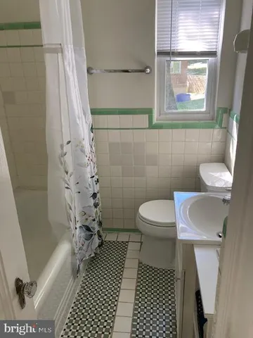 a bathroom with a toilet a sink and shower