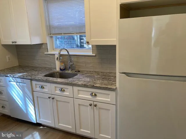 a kitchen with stainless steel appliances granite countertop a sink and a granite counter tops