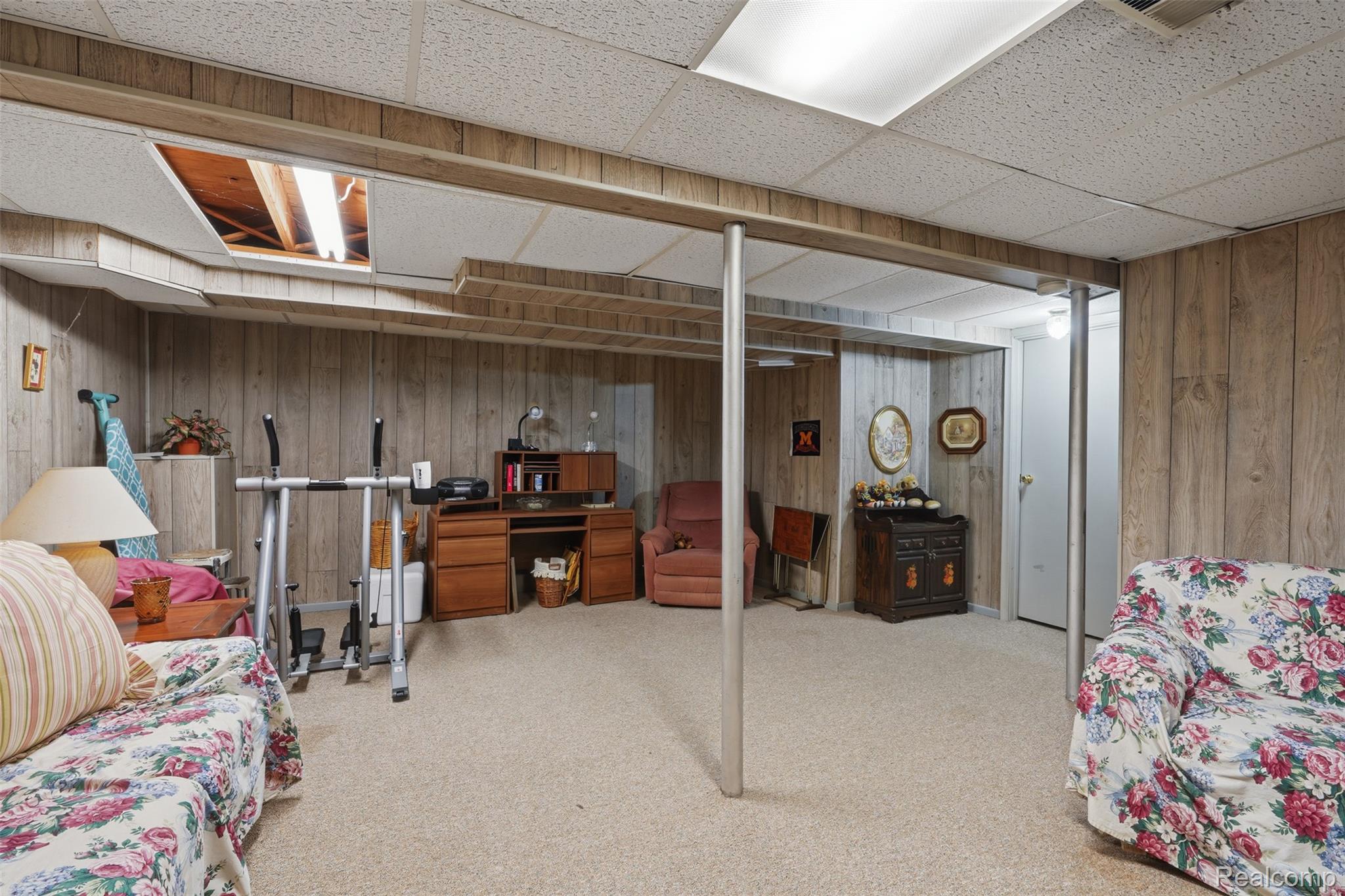 18160 Raleigh Square Drive Southgate, MI 48195 - Photo 25 of 31 Finished basement with wood-panel walls and light-colored carpeting