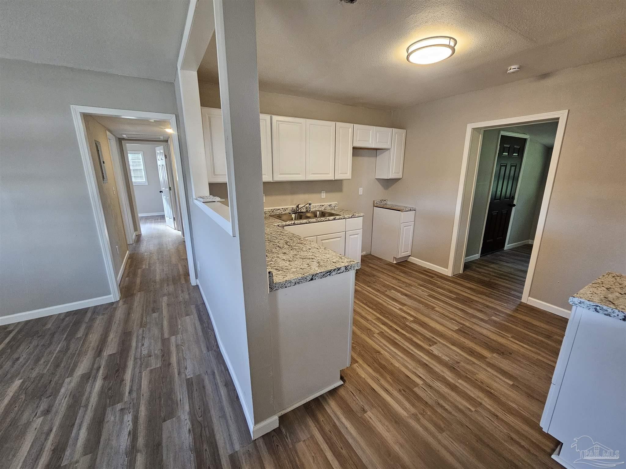 5357 Locklin Avenue Milton, FL 32570 - Photo 5 of 9 a view of a kitchen from a hallway