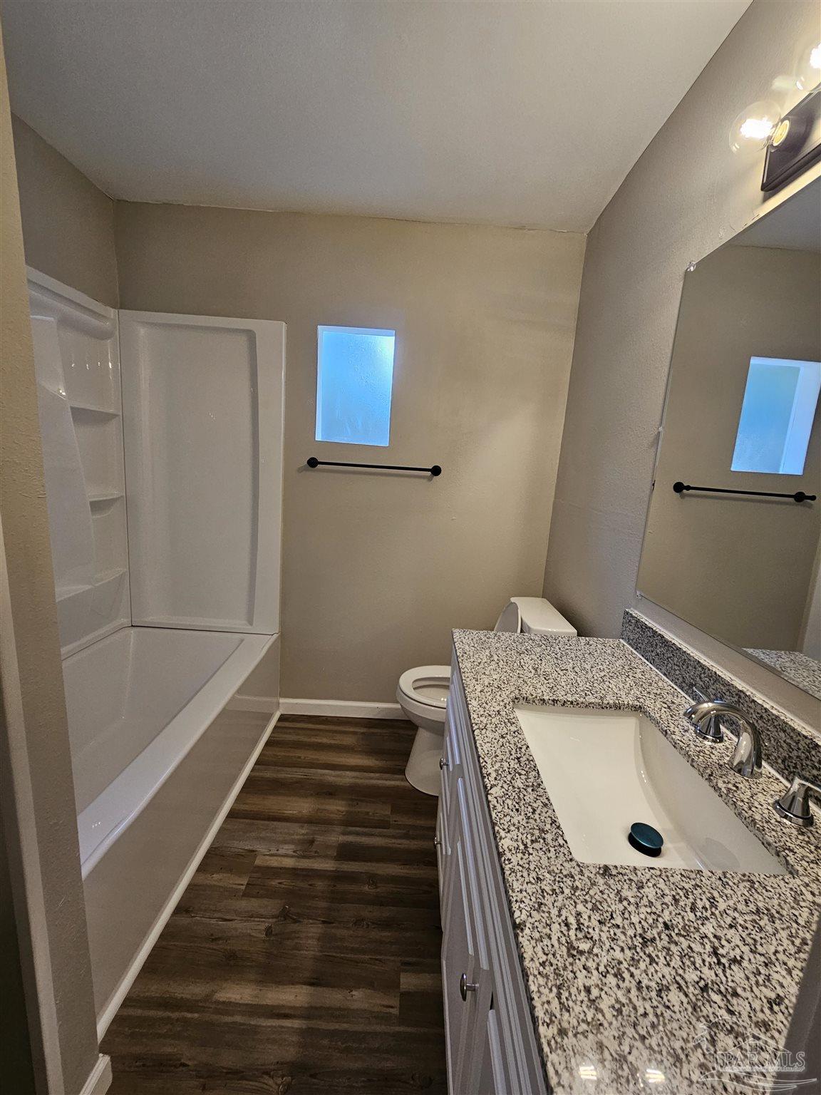 5357 Locklin Avenue Milton, FL 32570 - Photo 6 of 9 a bathroom with a tub and sink