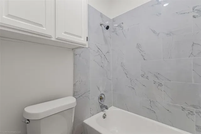 a bathroom with a toilet and bathtub