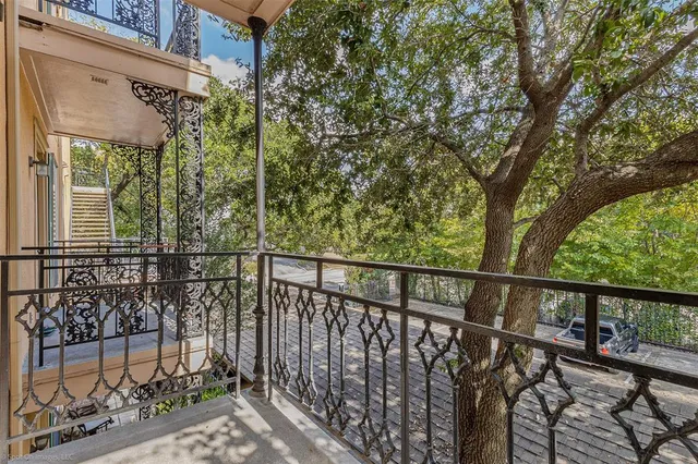 a view of a balcony with iron fence
