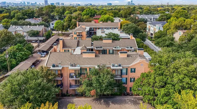an aerial view of multiple houses with yard