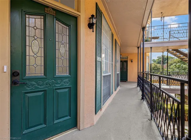 a view of a brick house with a door and windows