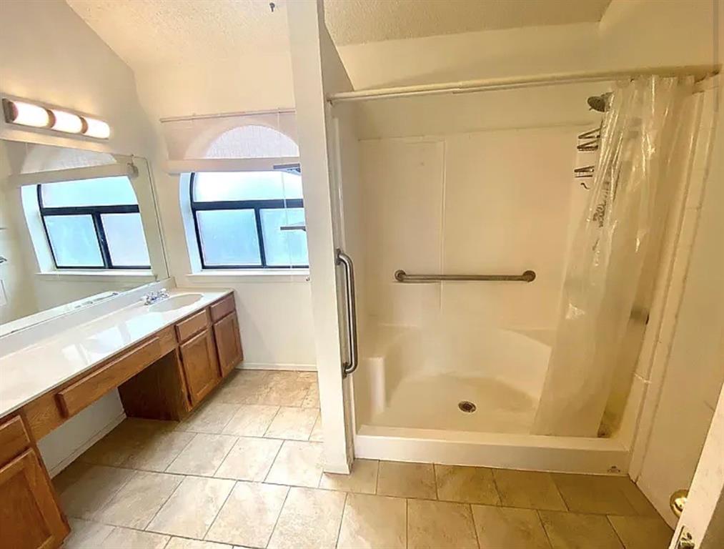 2614 Timberview Circle Corinth, TX 76210 - Photo 5 of 18 a bathroom with a granite countertop shower mirror and a sink