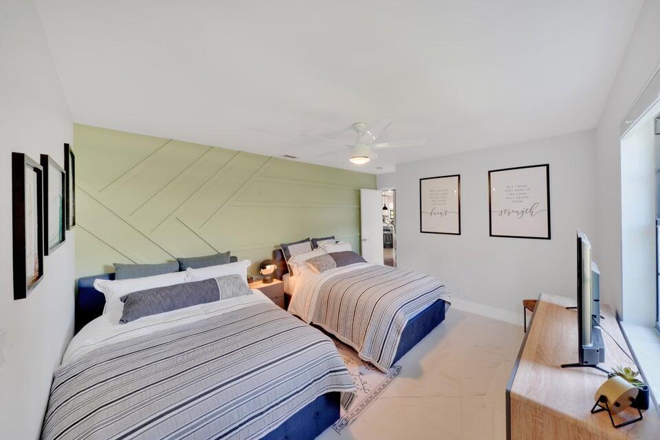 4526 St Andrews Drive Boynton Beach, FL 33436 - Photo 11 of 17 a bedroom with two beds and painting on the wall