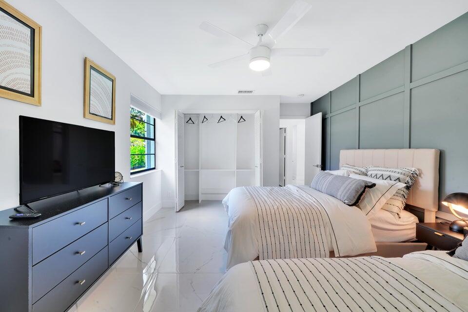 4526 St Andrews Drive Boynton Beach, FL 33436 - Photo 12 of 17 a bedroom with a bed and a flat screen tv