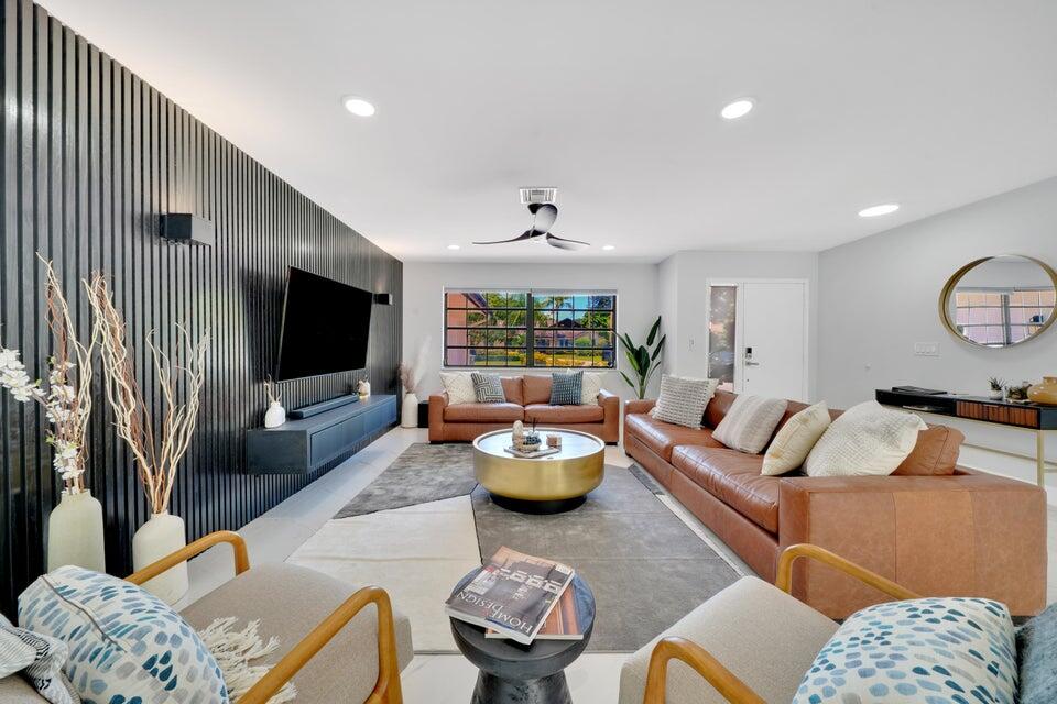 4526 St Andrews Drive Boynton Beach, FL 33436 - Photo 2 of 17 a living room with furniture and a flat screen tv
