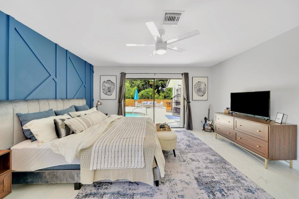 4526 St Andrews Drive Boynton Beach, FL 33436 - Photo 7 of 17 a bedroom with bed and flat screen tv