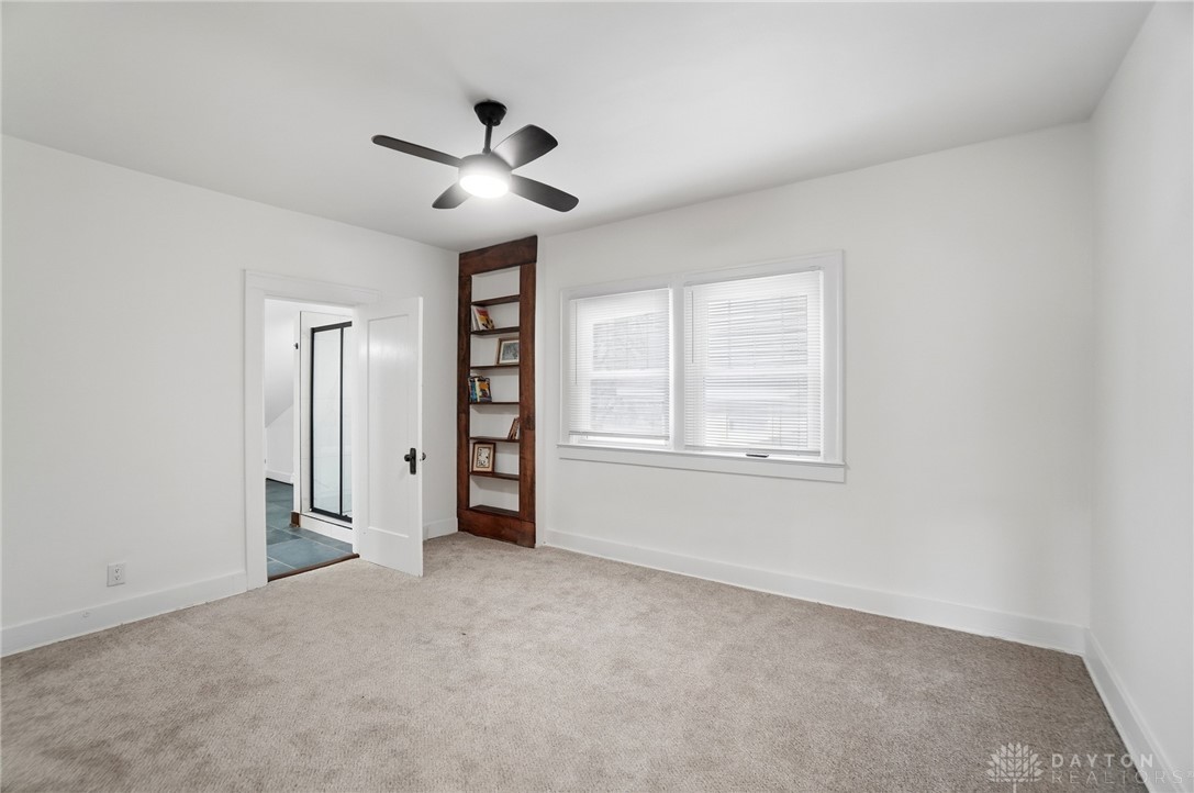 25 Englewood Road Springfield, OH 45504 - Photo 45 of 66 Bright and airy bedroom features soft carpeting, ample natural light, and a functional built-in bookshelf.