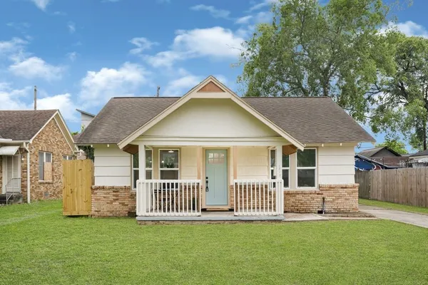 a view of a house with a yard and a garden