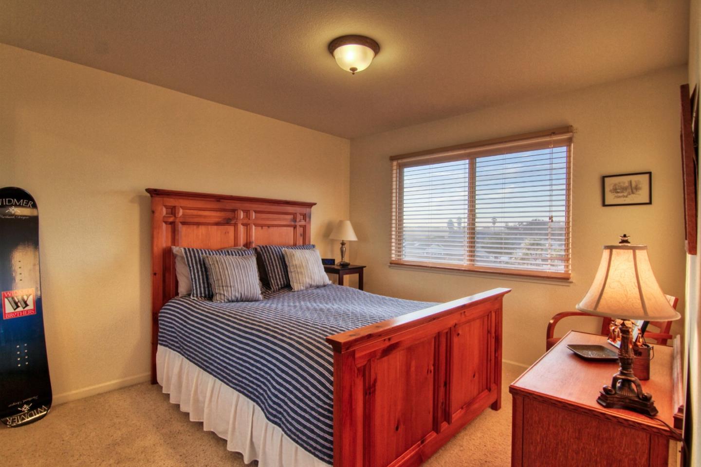 146 Katerina Lane Marina, CA 93933 - Photo 20 of 23 a bedroom with a bed and a flat screen tv